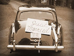 Just Married sign on back of old car